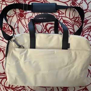Away Cream and Black Travel Bag